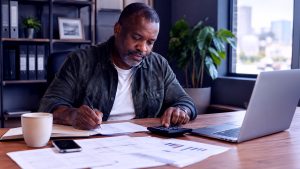 business loan requirements_business owner with calculator