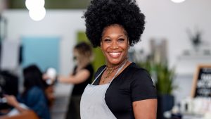 A small business owner excited business funding for her growing business.