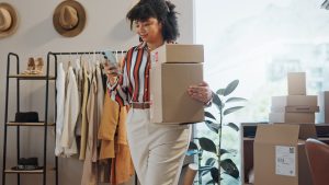 Small business owner carrying boxes.