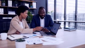 what is working capital_header image_man and woman in office with laptop